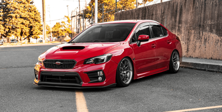 A red Subaru Sedan on the road