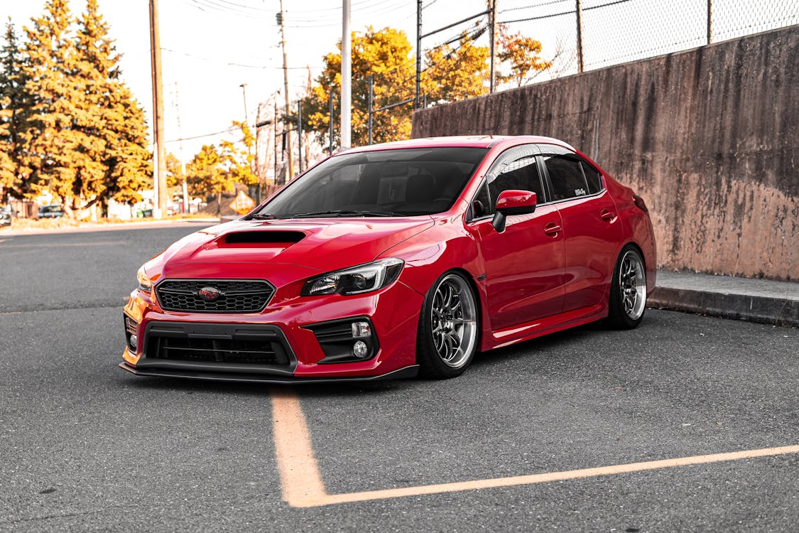 A red Subaru Sedan on the road